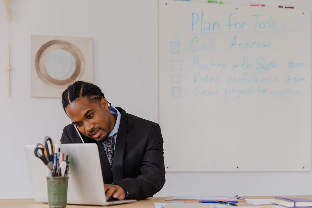 Photo by RDNE Stock project Businessman at his desk in an office working on a laptop and making phone calls.
