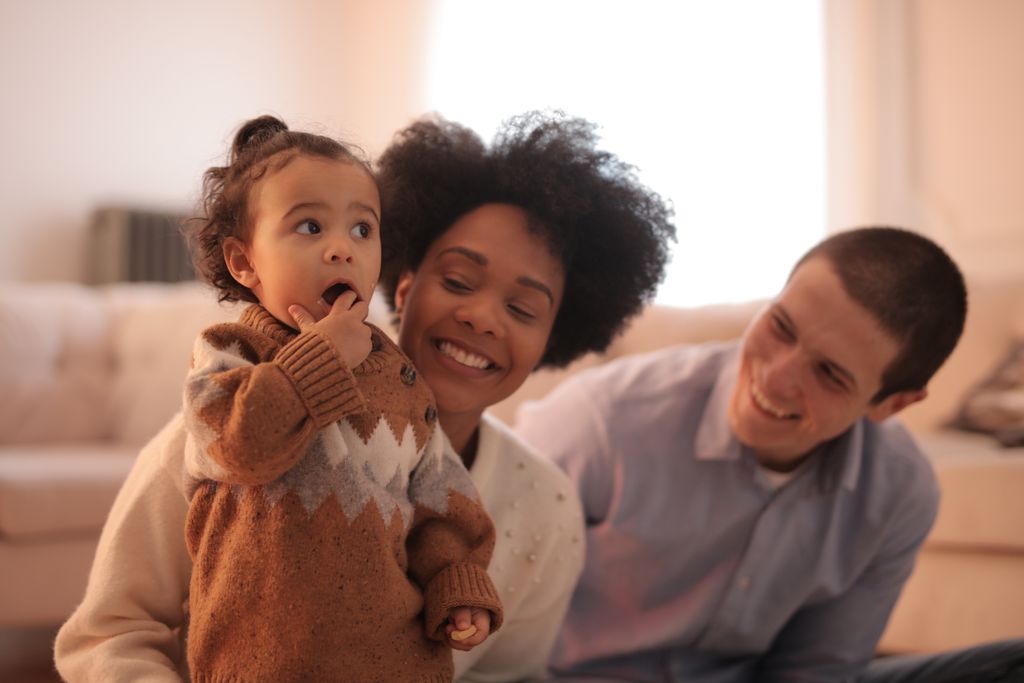 Photo by Andrea Piacquadio Happy family enjoying time with their child in a cozy living room.