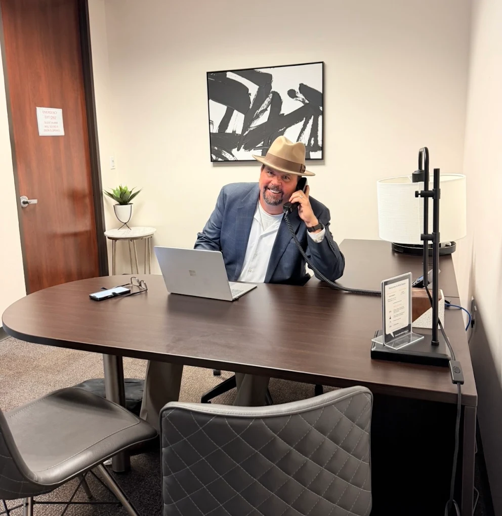 Jeff_Lambert-at-desk Jeff Lambert Life Insurace Agent in Austin Texas sitting at his desk talking to a client