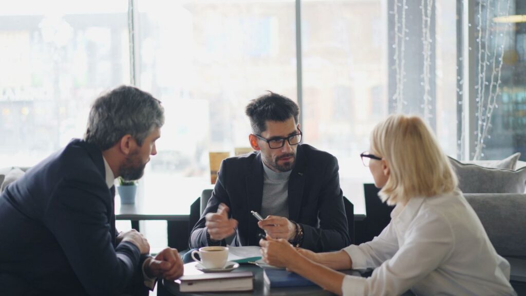 insurance-agent-talking-to-clients And insurance agents talking to clients at a table