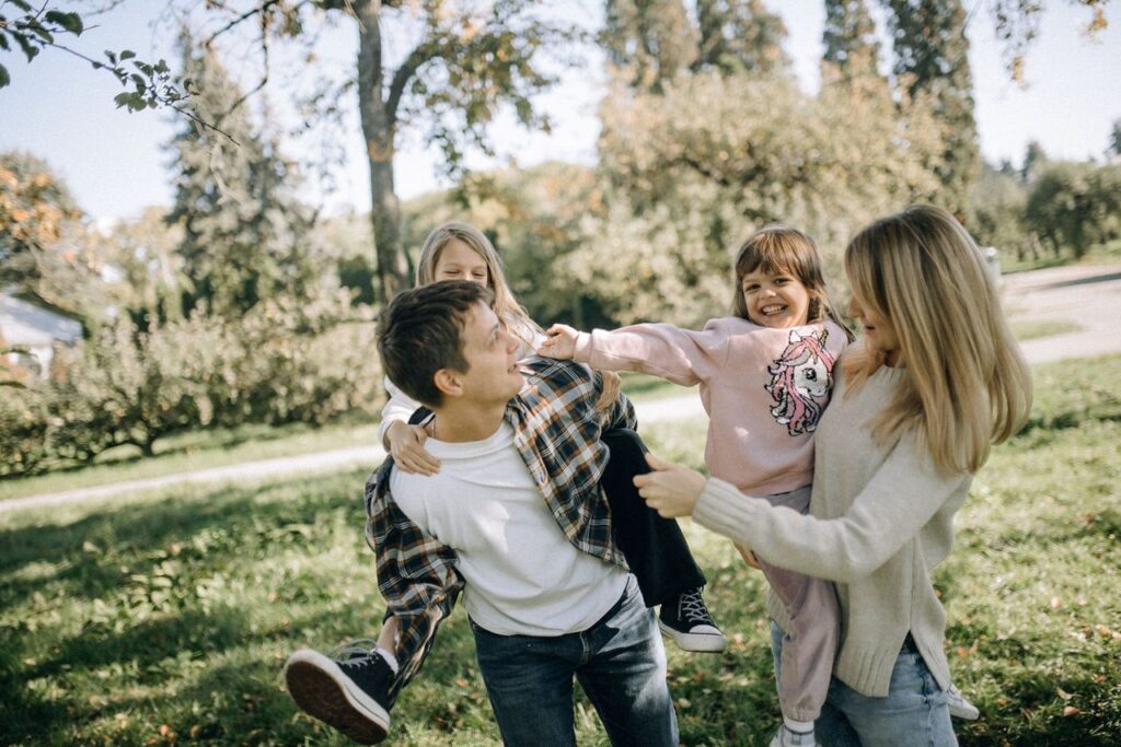 pexels-photo-18379520-18379520 A joyful family spending quality time together in a green park on a sunny day.