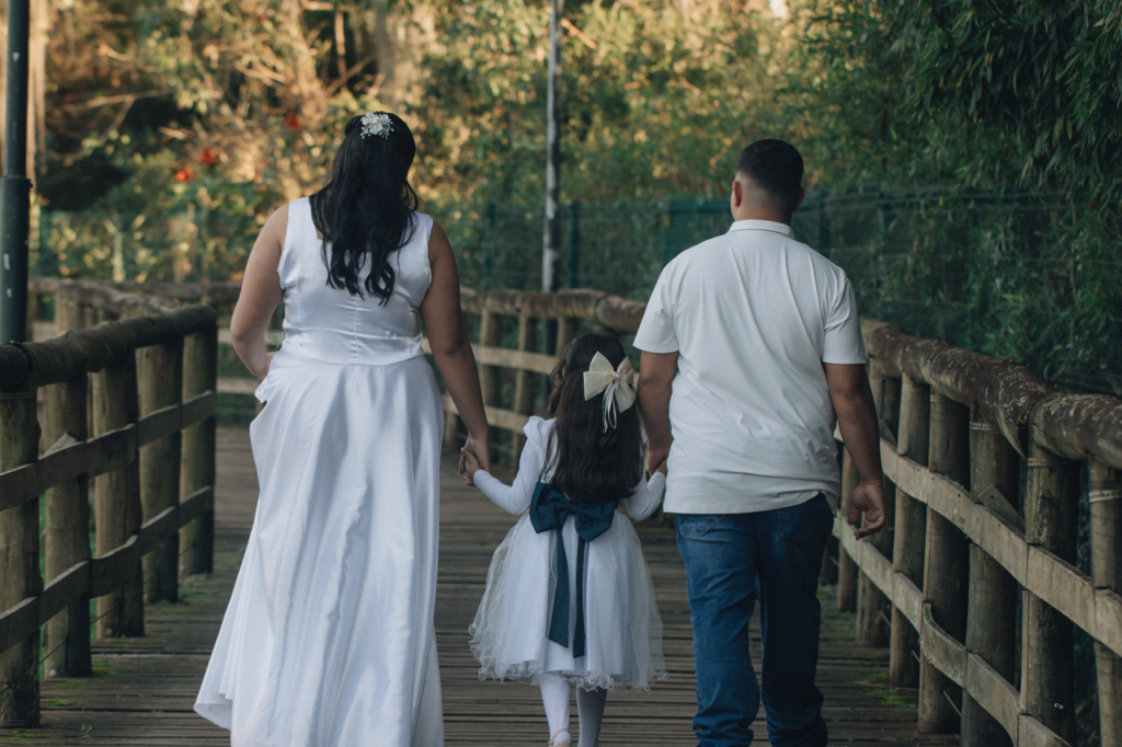 pexels-photo-38816415-38816415 A family walking on a wooden bridge in nature, captured in an outdoor setting.