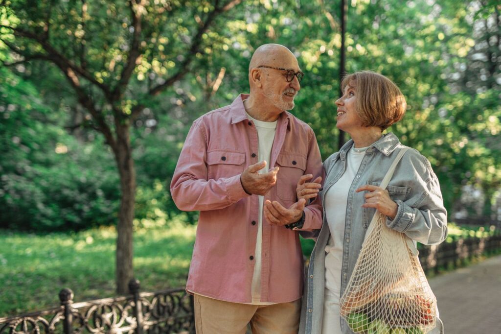 pexels-photo-8972500-8972500 Senior couple walking together in a park enjoying a conversation on a sunny day.